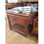 A Chinese hardwood side table, the square top over a frieze drawer and undershelf, on moulded square