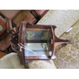 An Edwardian inlaid rosewood hanging corner shelf, the fret carved top over a galleried shelf and