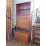 A G-Plan teak secretaire cabinet, with two open shelves above a fall front enclosing pigeonholes