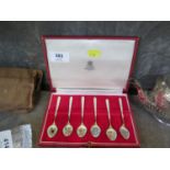 A set of six silver gilt enamelled coffee spoons decorated with flowers, S.J. Rose & Son