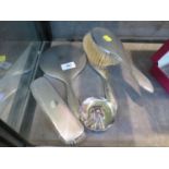 A four piece silver ladies brush and mirror set, and a plated candle holder