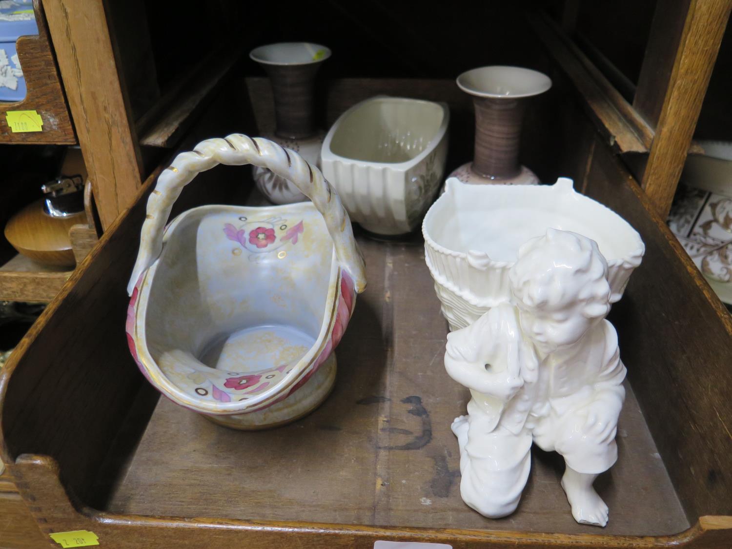 A 1930s Crown Ducal posy basket, together with three Jersey pottery vases and a white glazed boy