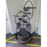 A copper garden water feature, with entwined rope design and pans, 125 cm high