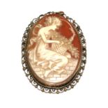 A carved cameo brooch, set in a metal frame