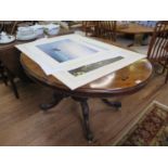 A Victorian burr walnut oval centre table, on a carved baluster stem with four carved cabriole