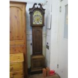 An early 20th century oak longcase clock, the swan neck pediment over a brass 10" dial with matted