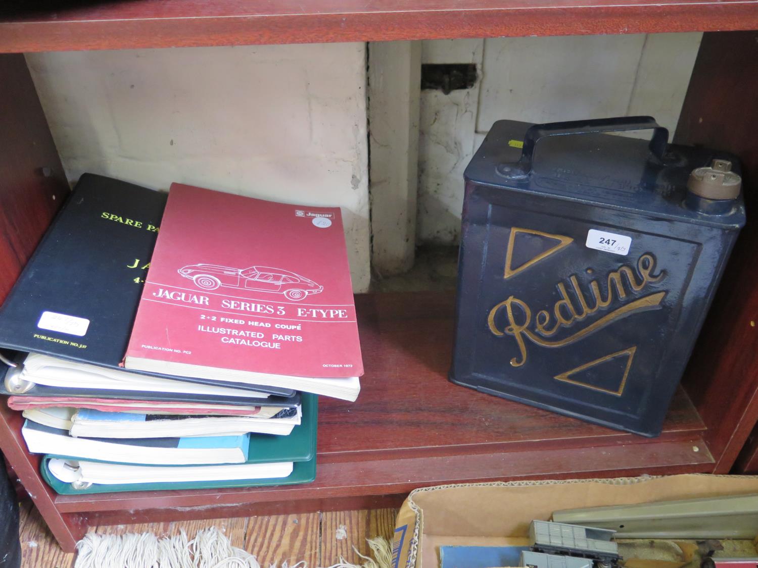 A 'Redline' motoring petrol can, and various Jaguar E-Type Service manuals and parts catalogues