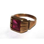 A 10 carat gold ring set with a red stone