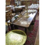 A 19th century French cherrywood and chestnut dining table, the rectangular top over a central