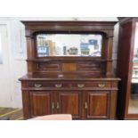 An Edwardian walnut mirror back sideboard, the moulded cornice over twin column supports and