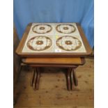 A G-Plan teak nest of three tables, the largest with tiled top, 49 cm wide
