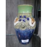 A Doulton Lambeth stoneware vase with slip tulip and hearts decoration