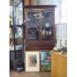 A George III style oak standing corner cabinet, with a pair of glazed doors over a pair of