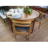 A teak extending circular dining table, and four dining chairs, 120 cm wide (5)