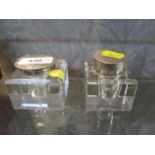Two glass ink wells with silver lids, one as found