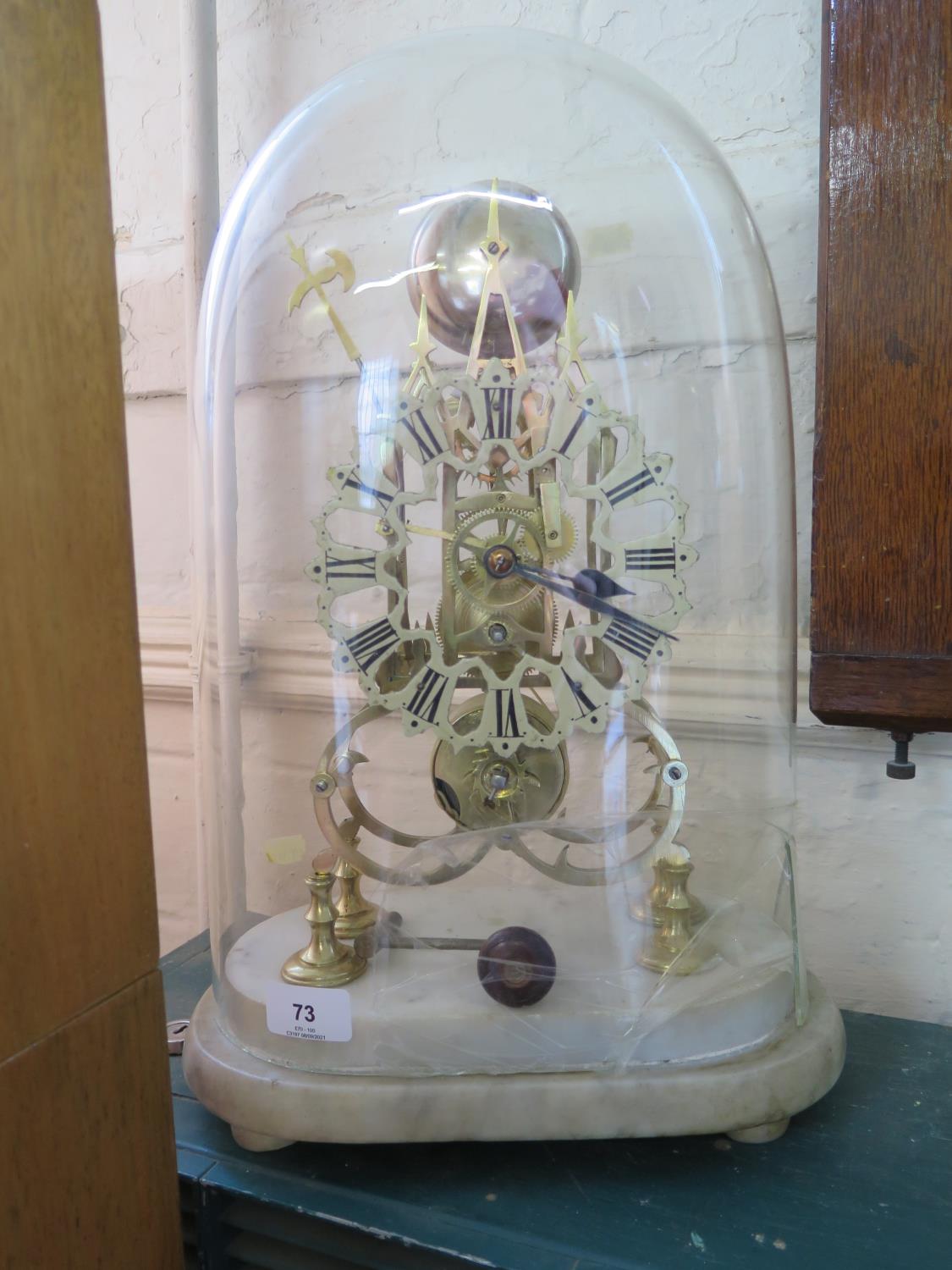 A Victorian brass skeleton clock, the enamelled dial on a scroll and spire frame, with marble base