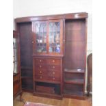 A mahogany breakfront bookcase cabinet, the moulded cornice over a pair of glazed doors above