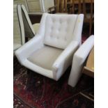 A 1950s cream faux leather armchair, the reclined button back on ebonised square moulded legs