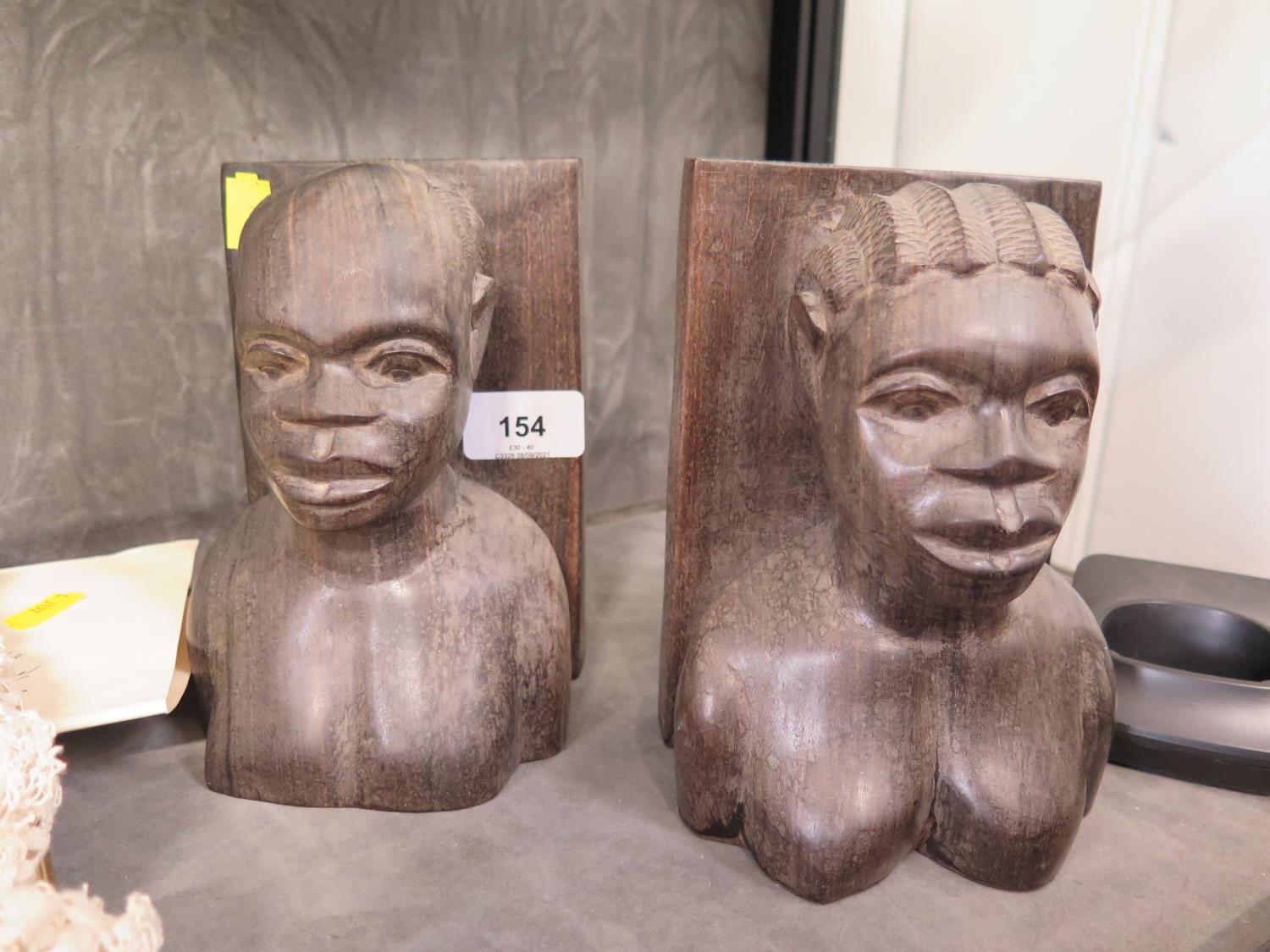 A pair of Kenyan ebony figural bookends, 17 cm high