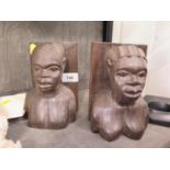 A pair of Kenyan ebony figural bookends, 17 cm high