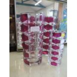 Three French maroon and clear glass vases, two 24cm high, one 16.5cm high