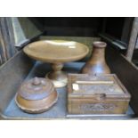 Four various treen items including a cake stand, trinket bowl and puzzle box