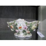 A Sitzendorf pierced floral basket, with applied flower heads, stamped 135 on the base, 24 cm wide