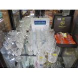 A pair of lead crystal champagne flutes, cased, a set of crystal drinking glasses, and a glass