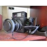 A Polaroid 600 SE camera, with Mamiya 127mm lens, and a Sachtler DV 4 video camera tripod (with