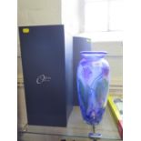 An Okra Glass vase by Dave Barras, the floral lustre design on a blue cloudy ground, etched