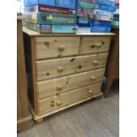 A pine chest of drawers, with two short and three long drawers on bun feet, 84 cm wide, 45 cm