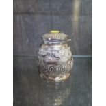A silver highly decorated ink well, with gadrooned and floral decoration, 8 cm high