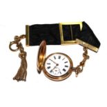 A ladies 14 carat gold fob watch attached to an 18 carat gold and ribbon fob