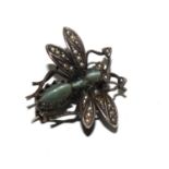 A white metal and seed pearl brooch in the form of a fly, with a cats eye set body