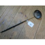 A silver toddy ladle with a 1757 coin set into the ladle base