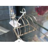 A four division toast rack on four ball feet