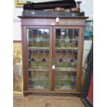 A late Victorian Art Nouveau style inlaid mahogany display cabinet, the raised back over lead glazed