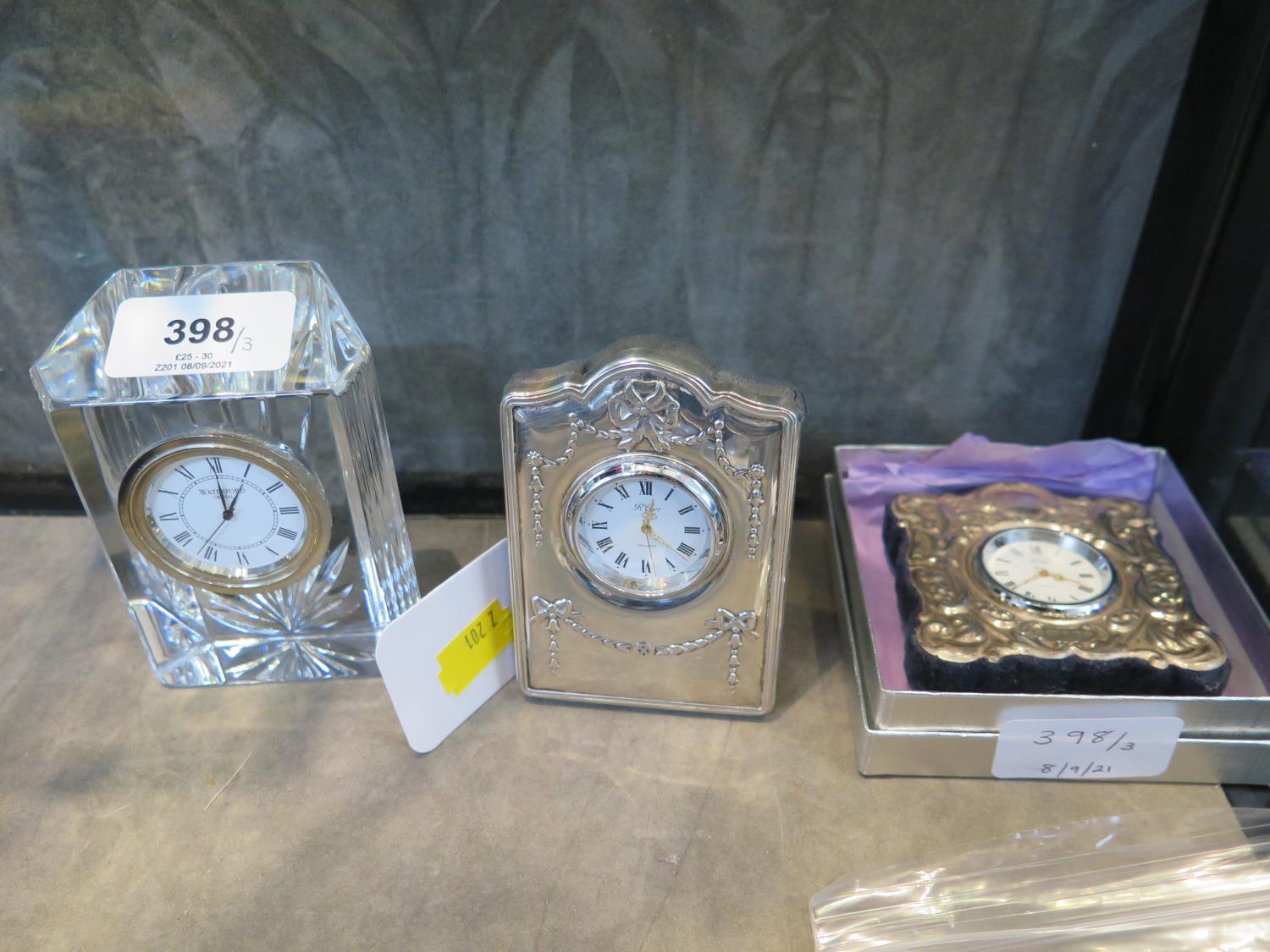 A Carrs of Sheffield silver bedside clock, 2000, and a Wedgwood crystal clock and another silver