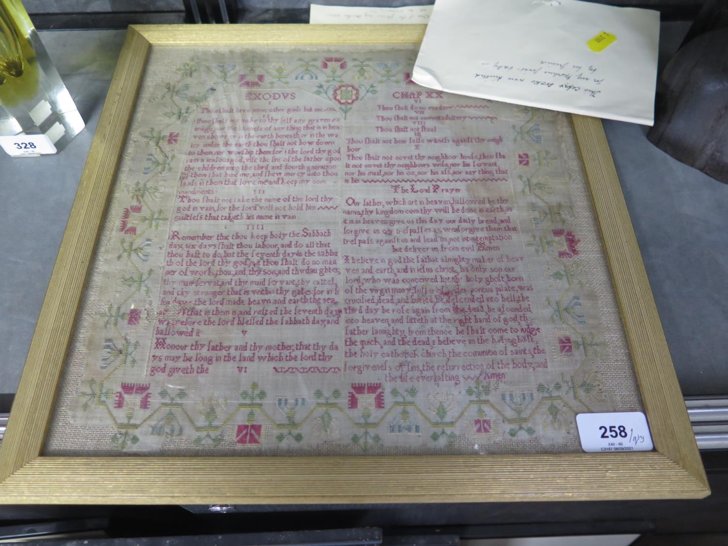 A 19th century lace table cloth, a child's lace bonnet, other textiles and a framed sampler - Image 2 of 2
