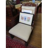 An Edwardian walnut lady's fire side chair, with carved top rail, button back and ring turned