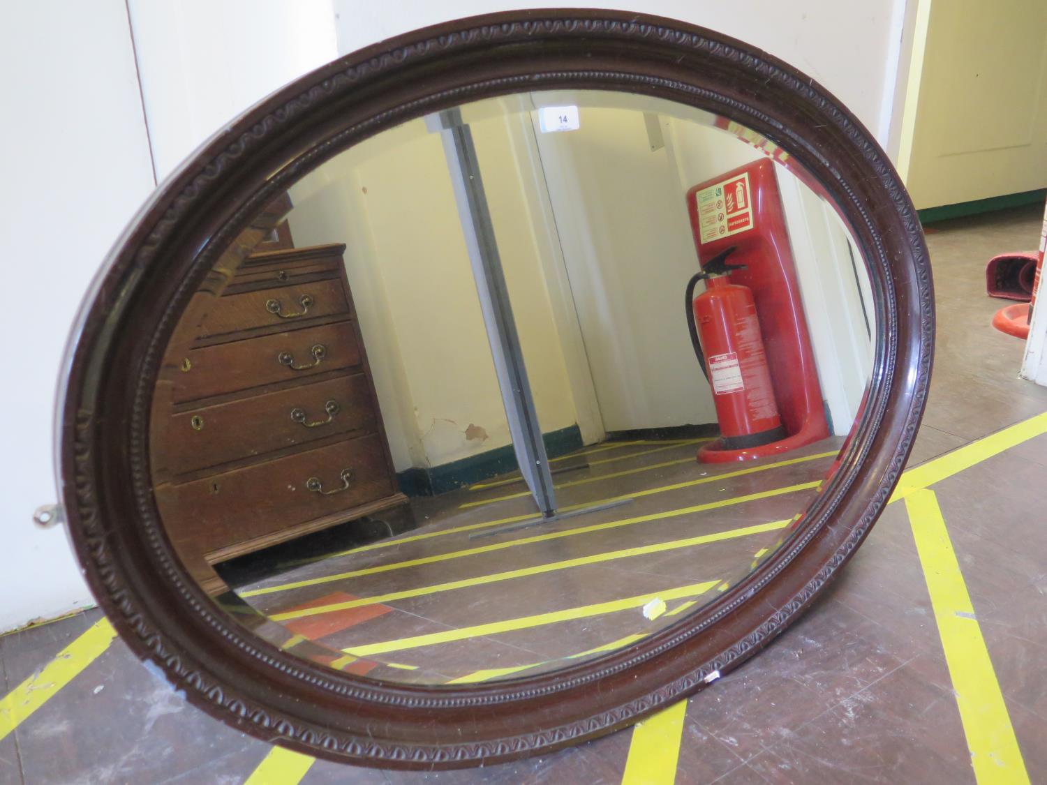 A 1920s oval mirror, with bevelled plate, within a cavetto beaded frame, 100 cm x 70 cm