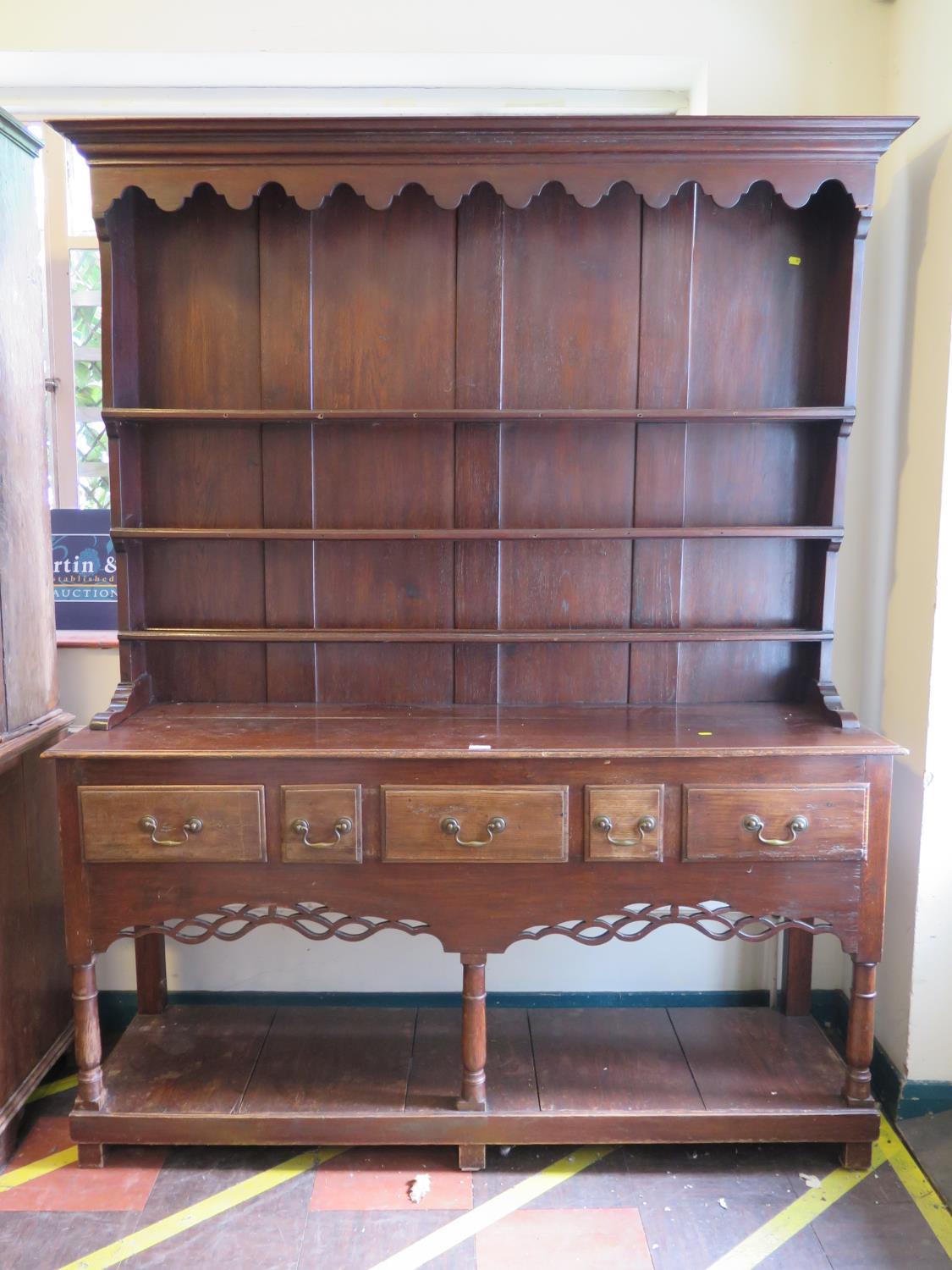 A George III style stained oak dresser and rack, the stepped rack over a base with five frieze