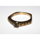 A 9 carat gold ring set with black stones. Size M