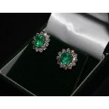A pair of 18ct white gold emerald and diamond cluster stud earrings. Emeralds 2.17ct, diamonds 0.98