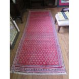 A Persian Sarouk Mir design runner, with allover boteh design on a red ground, 300 x 109 cm