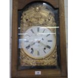 An 19th century French comtoise longcase clock, stained pine case with gilded repousse dial