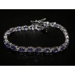 18ct white gold oval tanzanite and diamond line bracelet. Tanzanite 8.91ct approx. Diamonds 0.55ct