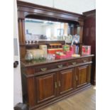 An Edwardian walnut mirror back sideboard, the moulded cornice over twin column supports and