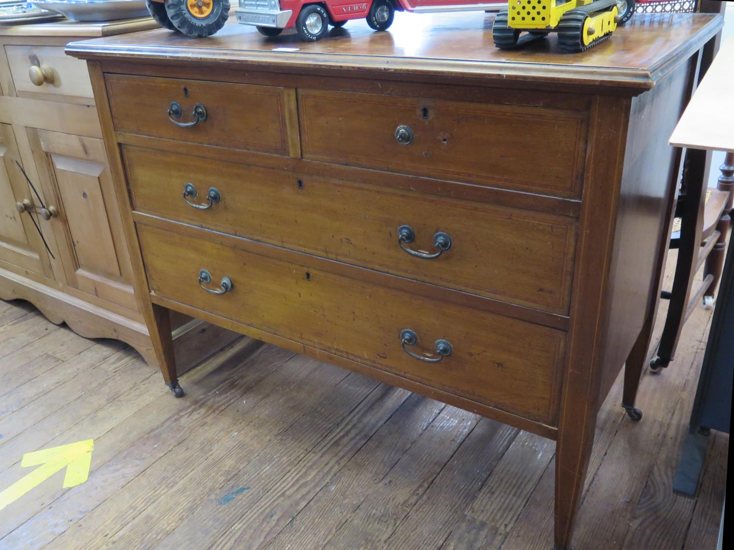 An Edwardian mahogany and satinwood crossbanded bedroom chest, with two short and two long drawers