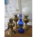A Victorian pressed blue glass oil lamp, by Sail Boat Brand Hong Kong, and three other brass oil
